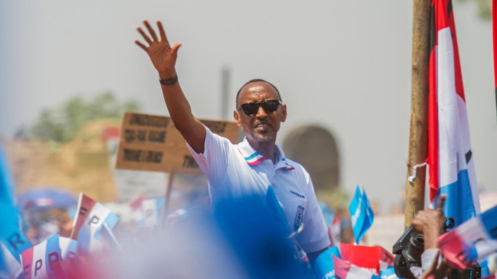 Rwandan President Paul Kagame of the ruling Rwandan Patriotic Front waves to his supporters during his final campaign rally in Kigali